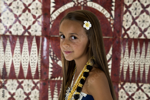 Young tan girl with tapa cloth background