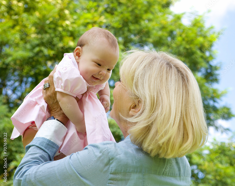 Grandmother lifting grandchild up and playing Grandmother lifting grandchild up and playing