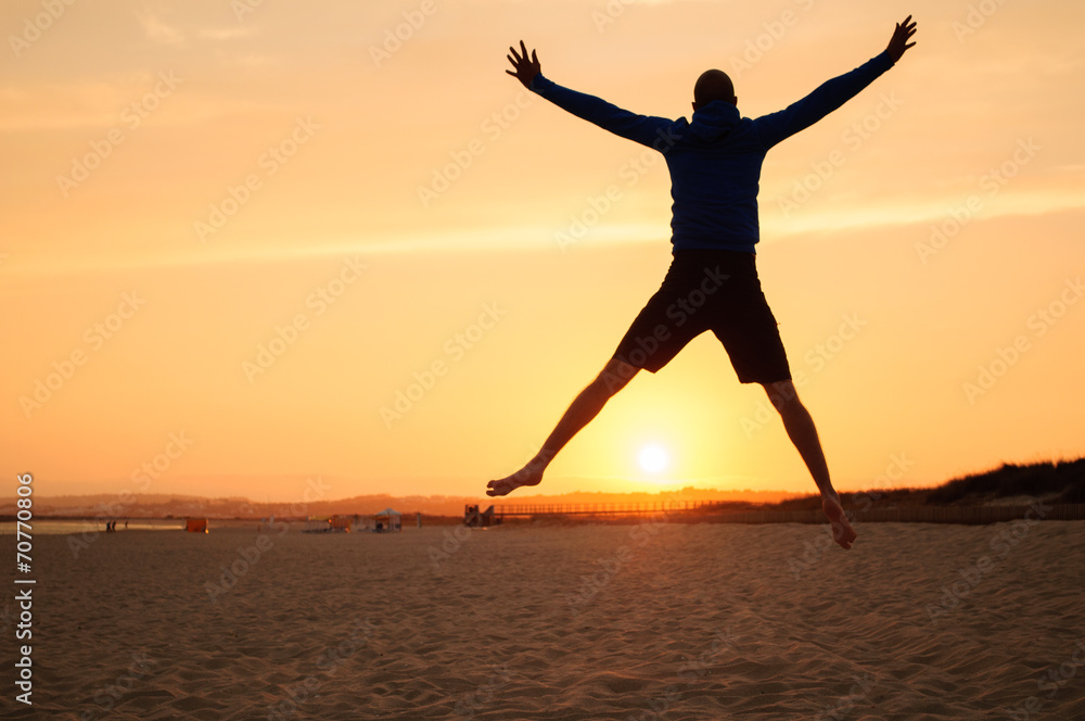 Man silhouette. Jumping in the beach at sunset Man silhouette. Jumping in the beach at sunset