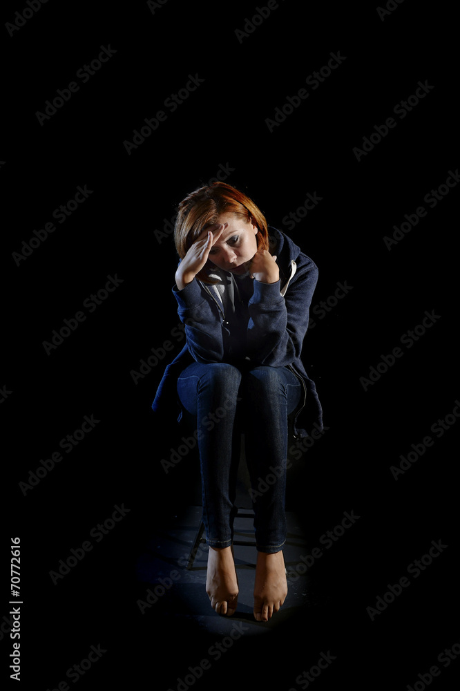 attractive woman suffering depression isolated on black