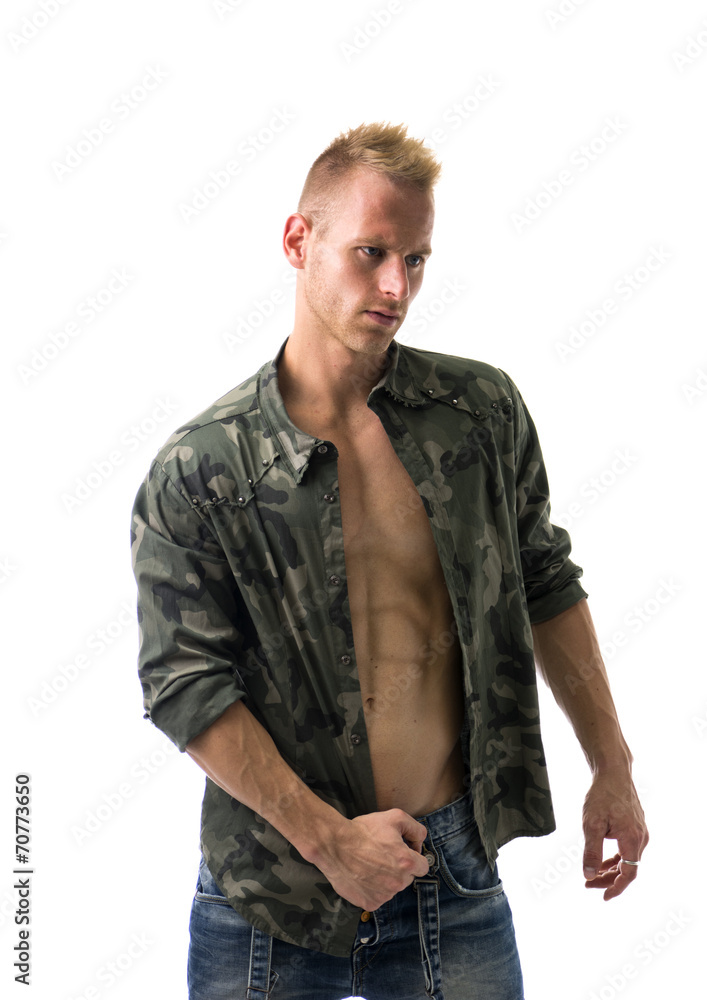 Fit male model wearing camouflage jacket on naked chest Fit male model wearing camouflage jacket on naked chest