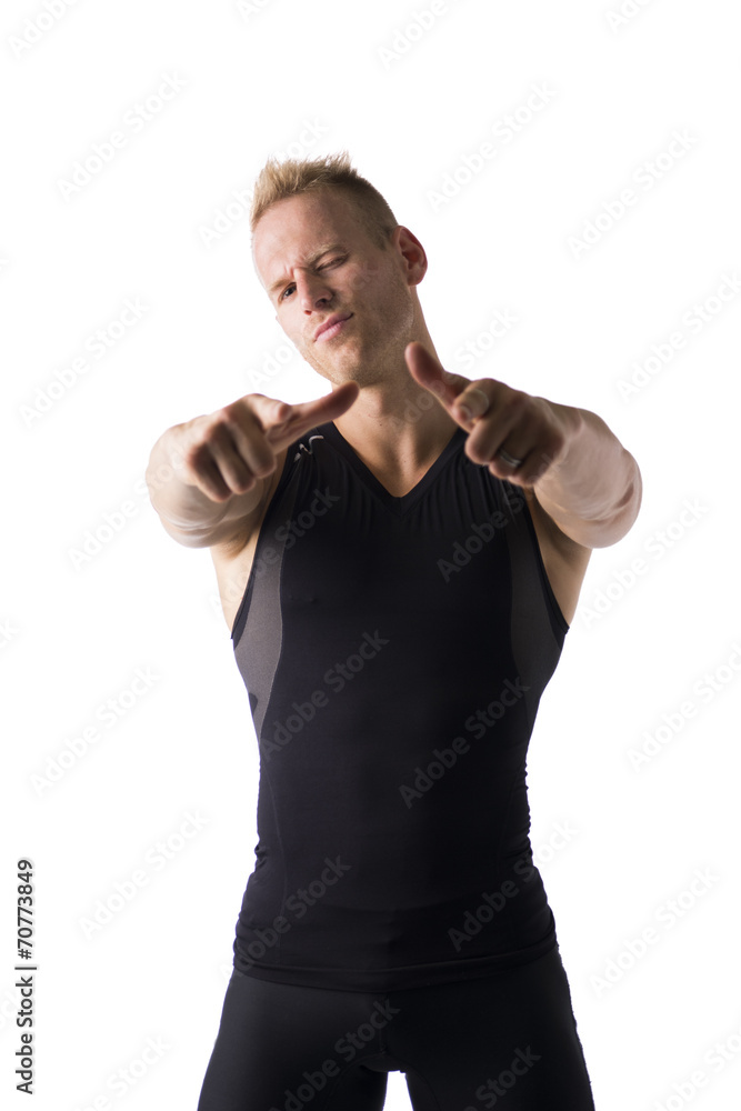 Fit male model smiling and pointing finger to camera Fit male model smiling and pointing finger to camera