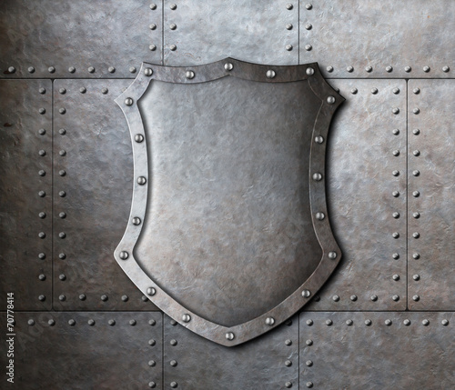 Fotografering metal shield over armor plates background