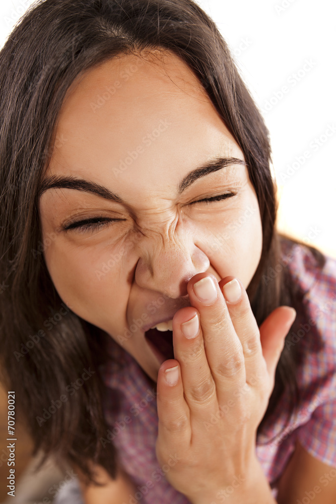 sleepy girl yawns and covers her mouth with her hand sleepy girl yawns and covers her mouth with her hand