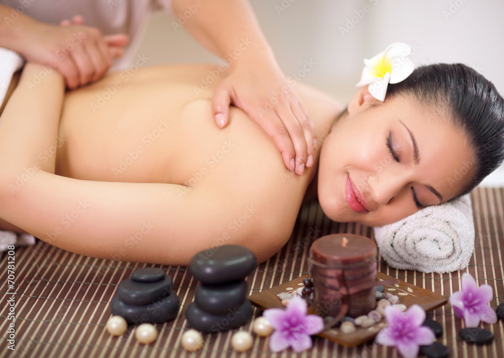 Beautiful woman having a wellness back massage at spa salon Beautiful woman having a wellness back massage at spa salon