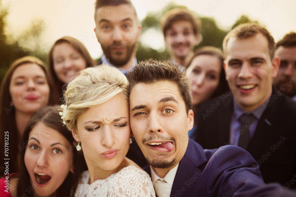 Newlyweds with friends taking selfie Newlyweds with friends taking selfie