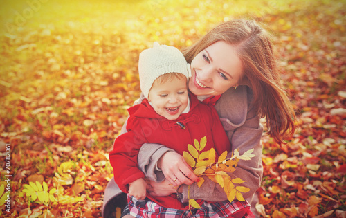 happy family: mother and child little daughter on autumn