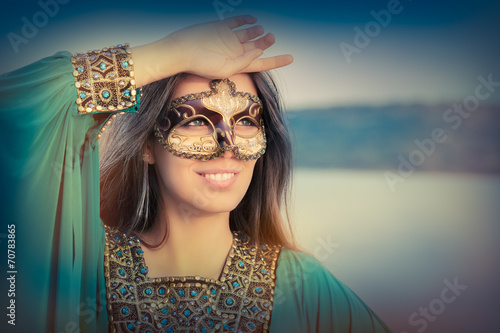 Young Woman Wearing Mask  and Oriental Dress
