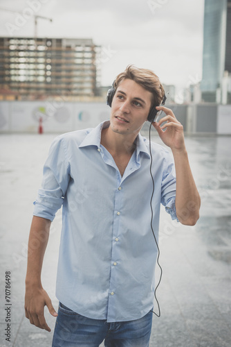 young model hansome blonde man with headphones