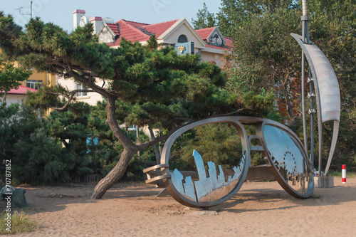 Sculpture of mirror points on a beach photo