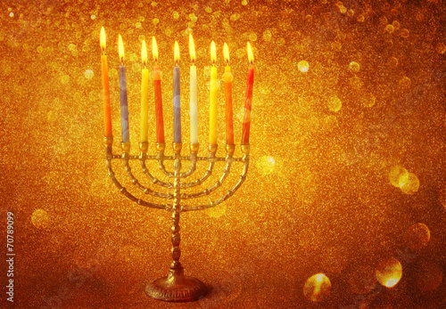 menorah with candels and glitter lights background. hanukkah con