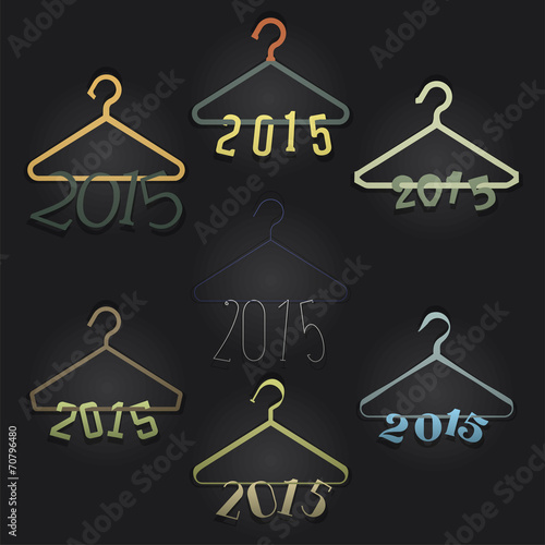 Set of 7 Hangers with Numerals Hanging: 2015. Black backdrop.