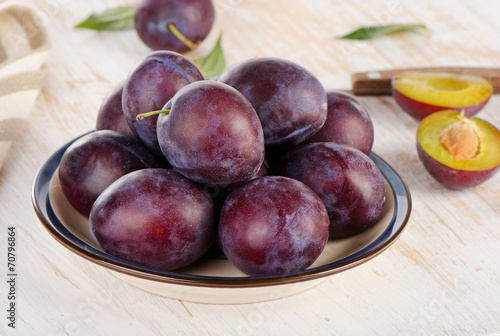 Fresh Plums on a wooden background