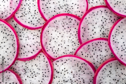 Fotografija beautiful fresh sliced white with red rim dragon fruit  as backg
