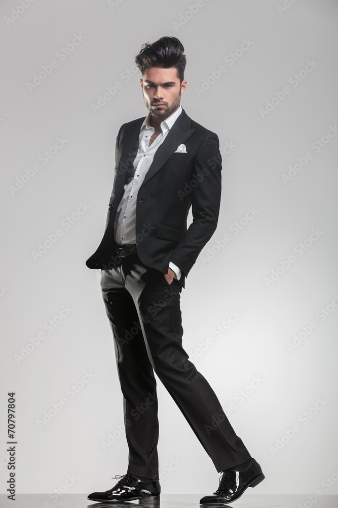 elegant young man in tuxedo walking elegant young man in tuxedo walking