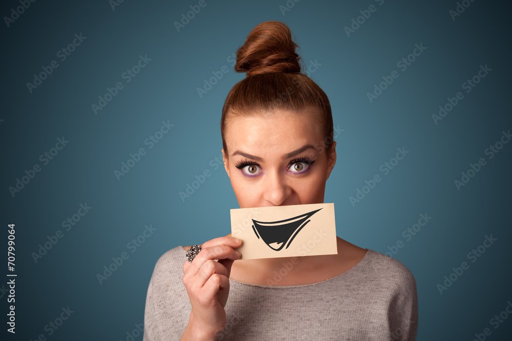 Happy cute girl holding paper with funny smiley drawing Happy cute girl holding paper with funny smiley drawing