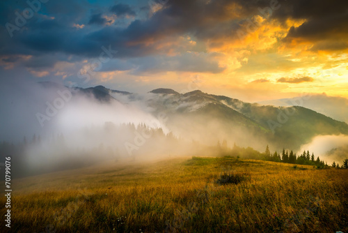 Amazing mountain landscape with fog and a haystack