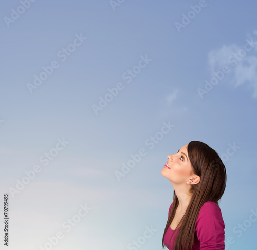 Girl looking at the blue sky copyspace
