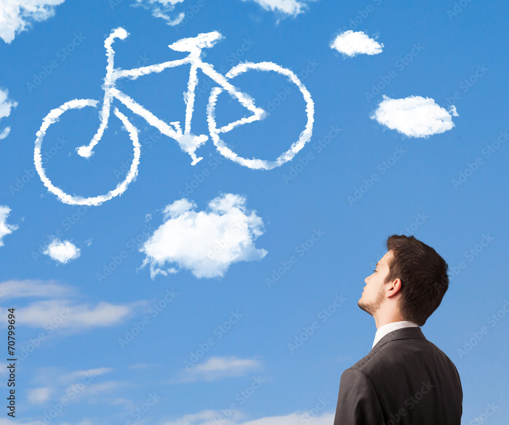 Young man looking at bicycle clouds on blue sky