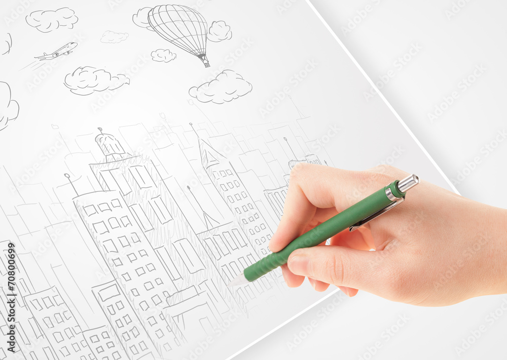 A person drawing sketch of a city with balloons and clouds on a A person drawing sketch of a city with balloons and clouds on a