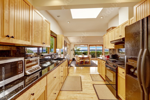 Empressive kitchen interior with shiny black granite tops photo