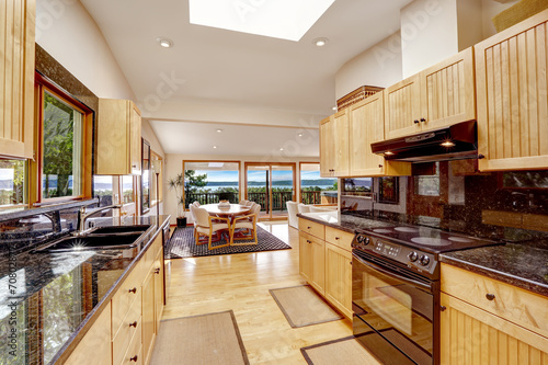 Empressive kitchen interior with shiny black granite tops