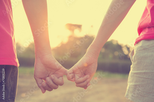 couple holding hands in wedding outdoor theme