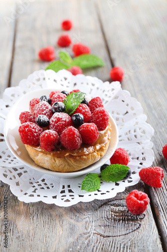 Sweet cakes with berries on table close-up