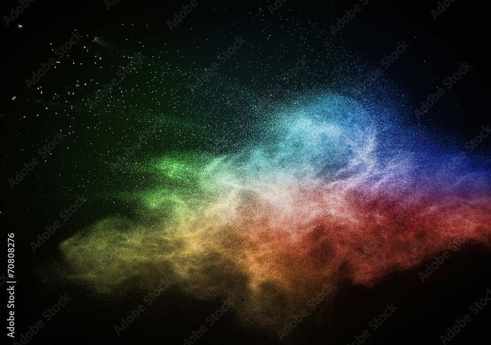 Colourful powder exploding isolated on black