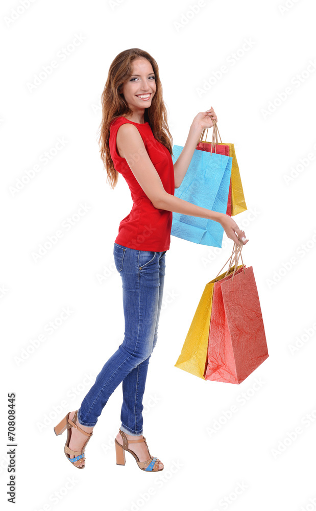 Beautiful young woman with shopping bags isolated on white