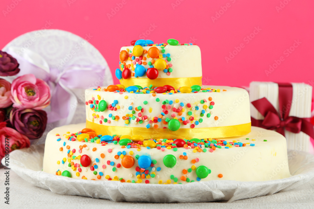 Beautiful tasty birthday cake and gifts on color background Beautiful tasty birthday cake and gifts on color background