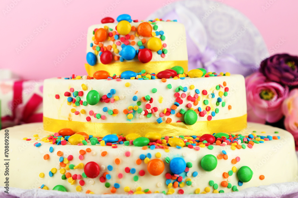 Beautiful tasty birthday cake and gifts on color background Beautiful tasty birthday cake and gifts on color background