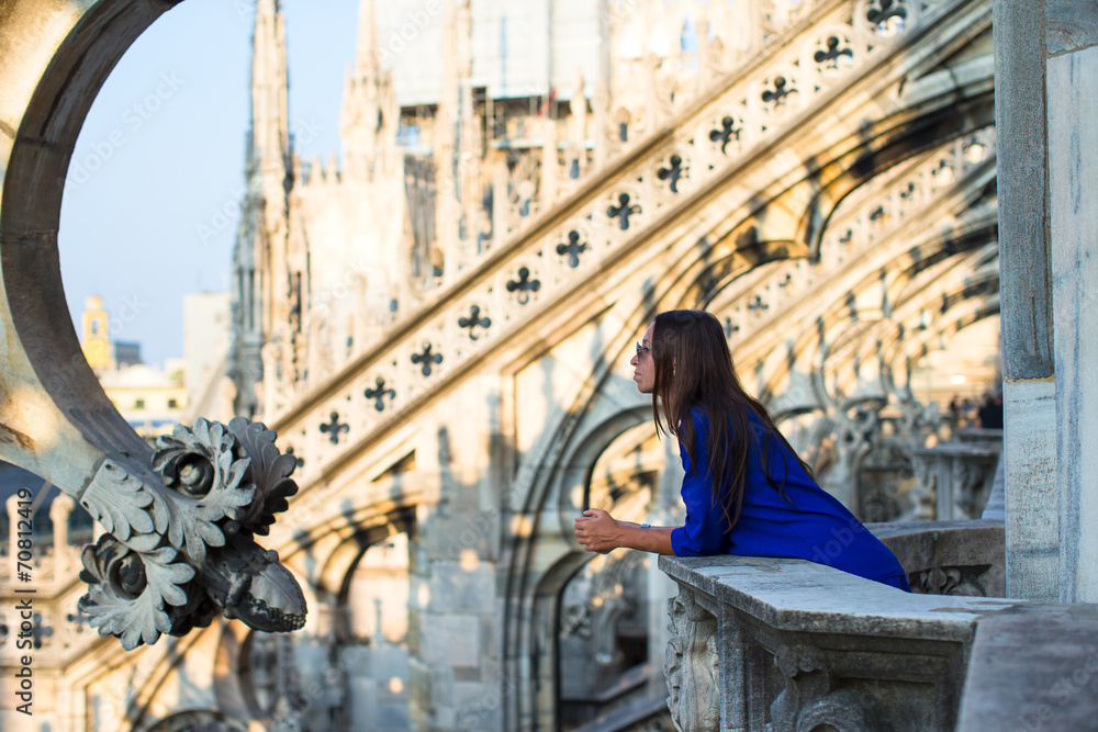 Beautiful woman on on the rooftop of Duomo, Milan, Italy
