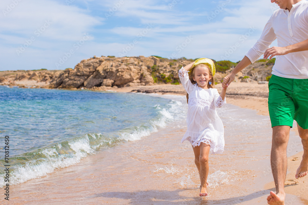 Happy father and adorable little girl outdoors during beach Happy father and adorable little girl outdoors during beach