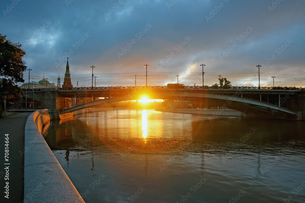 First rays of sunlight under the big stone bridge near Kremlin
