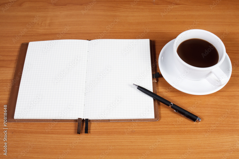 Open a blank white notebook, pen and cup of coffee on the desk Open a blank white notebook, pen and cup of coffee on the desk