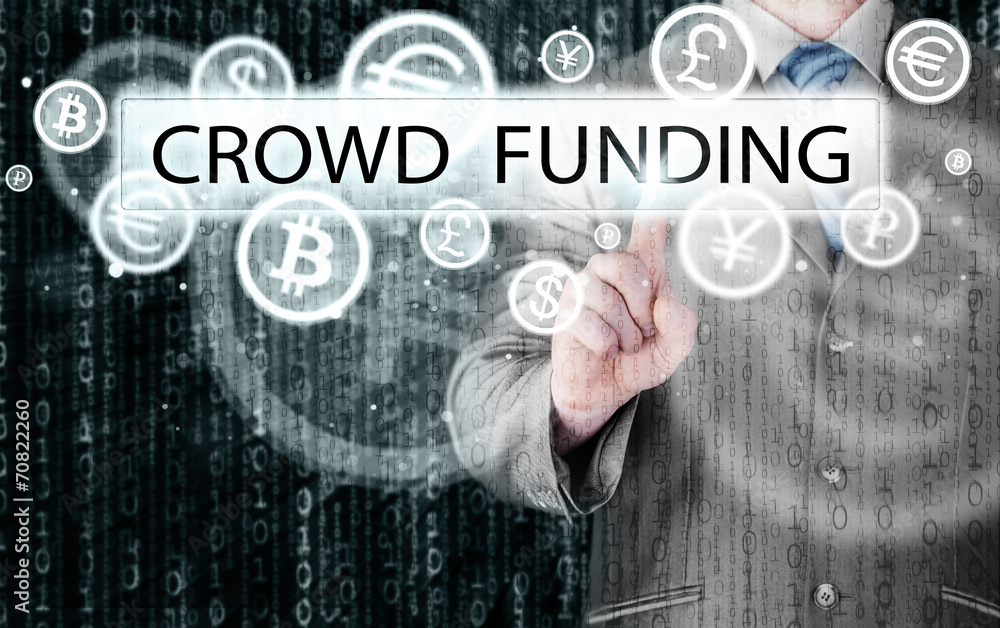 Businessman pushes virtual crowd funding button Businessman pushes virtual crowd funding button