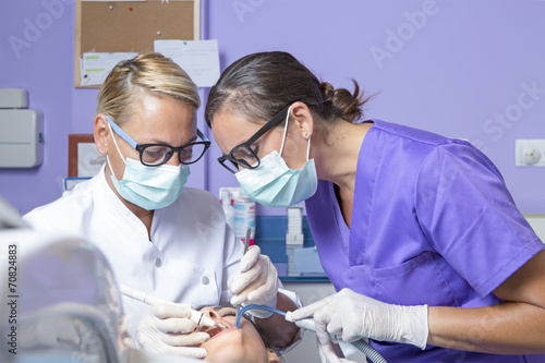 female dentist working with her assistant