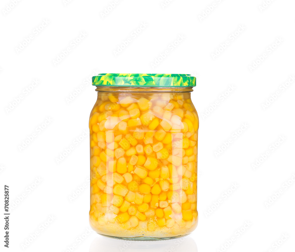 Glass jar full of corn. Glass jar full of corn.