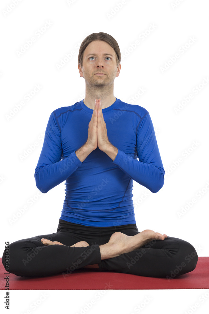 Man sitting and meditating during yoga Man sitting and meditating during yoga