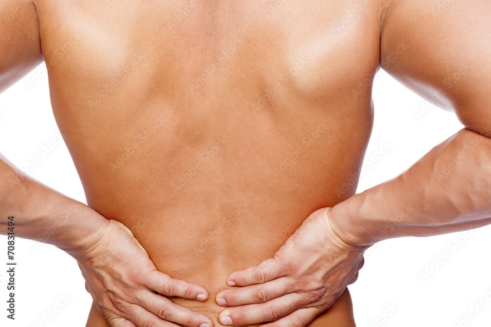 Rear view of a young man holding his back in pain, isolated on w Rear view of a young man holding his back in pain, isolated on w