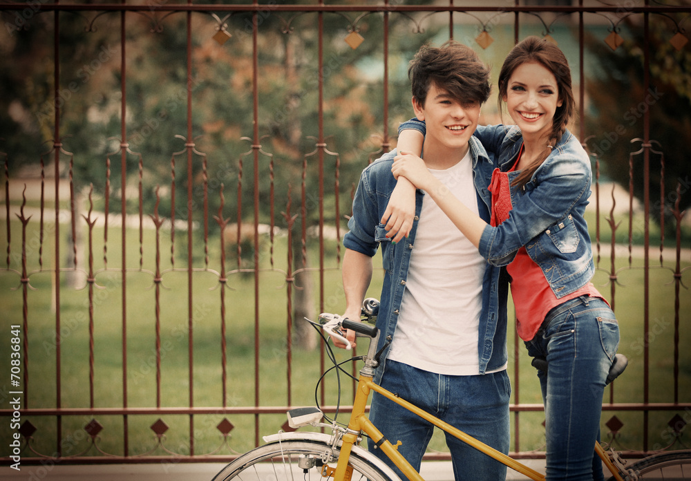 Young couple with bicycle outside