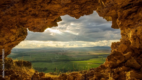 Cueva al atardecer con rayos de sol photo