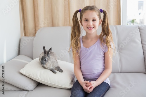 Cute little girl with her pet bunny