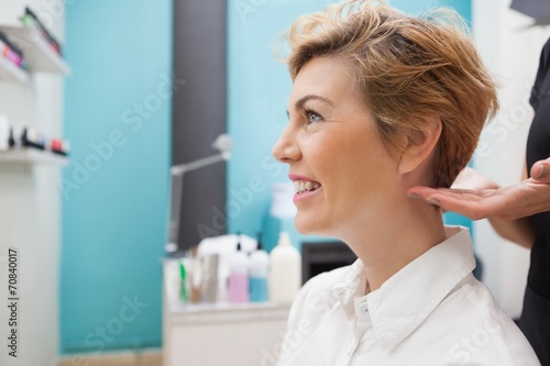 Hairdresser styling customers hair