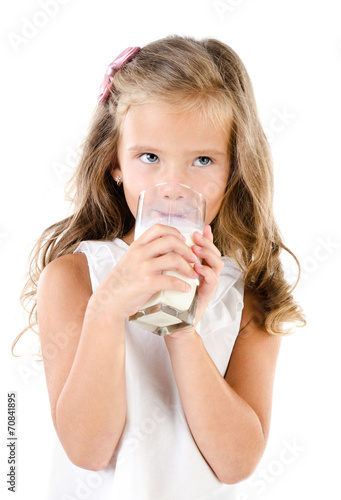 Smiling little girl drinking milk isolated on a white