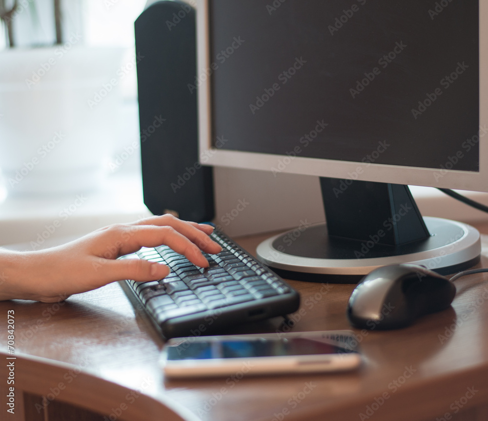 Female office worker typing on the keyboard Female office worker typing on the keyboard
