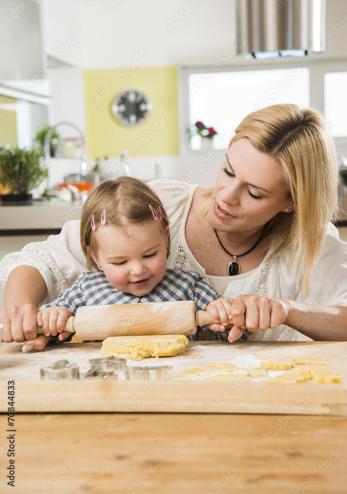 Mother and daughter baking in kitchen at home Mother and daughter baking in kitchen at home