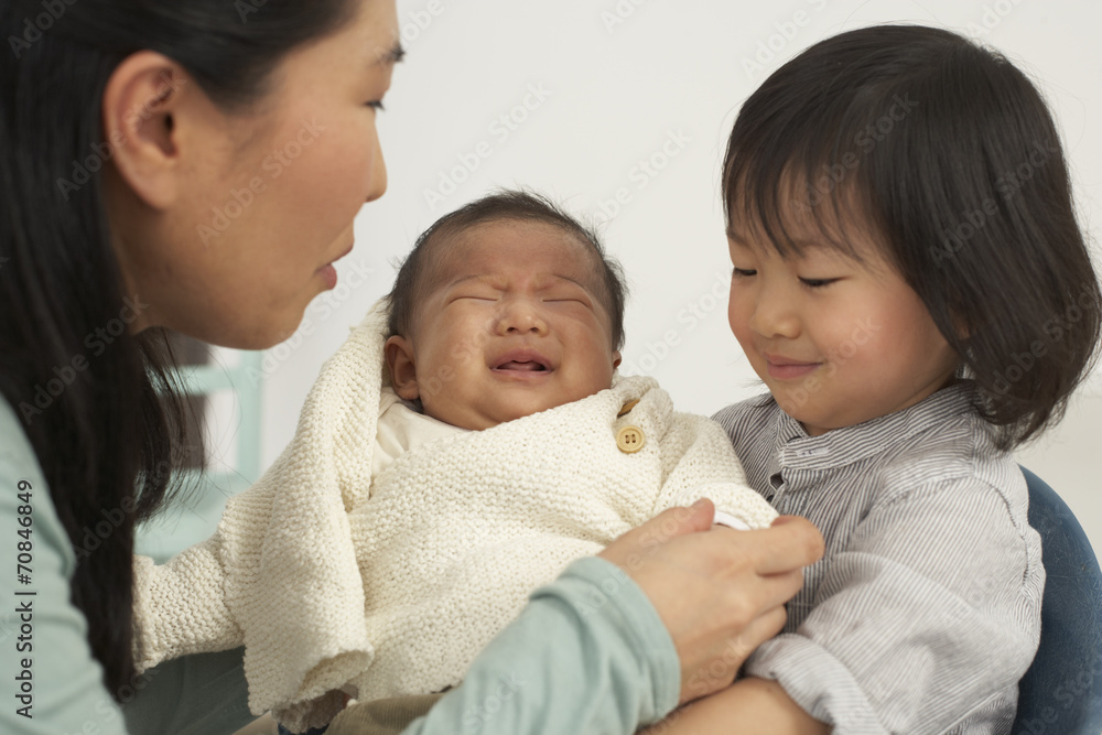 Asian mother with toddler and baby Asian mother with toddler and baby