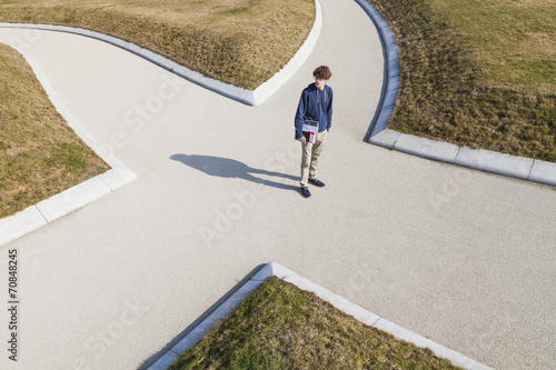 Germany, Baden-Wurttemberg, Teenage boy standing at crossing photo